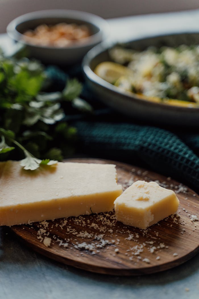 Close-up of fresh cheese on a rustic wooden board with salad, perfect for food photography.